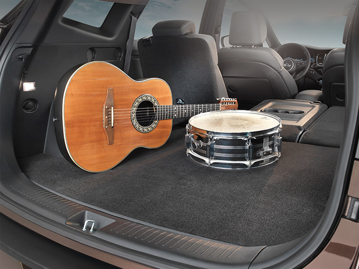 Car with a trunk mat, music equipment is laying on it