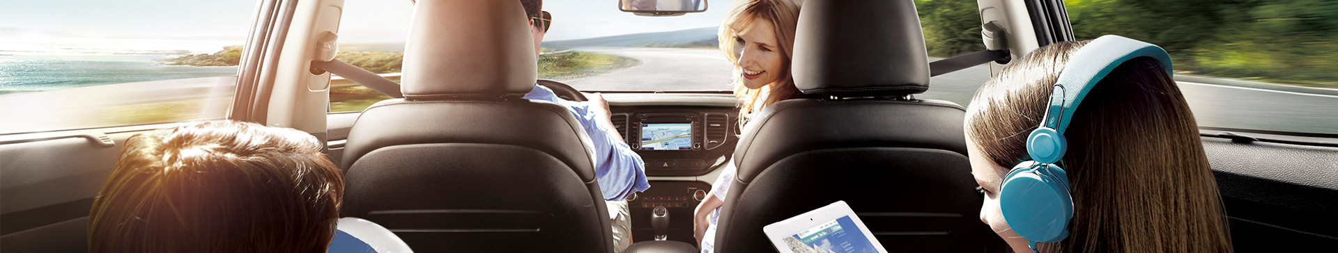 Girl using a tablet that is connected to the car