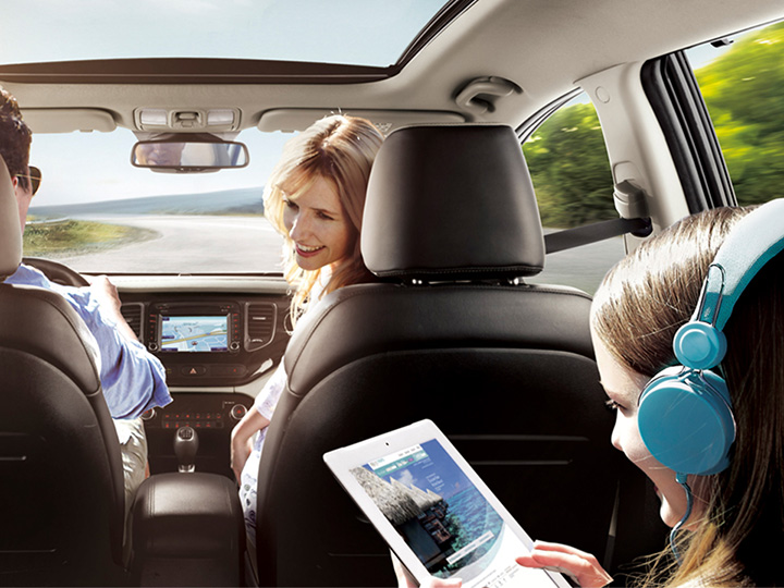 Girl using a tablet that is connected to the car