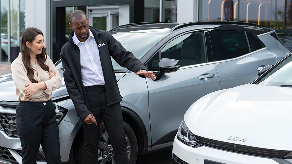 Kia dealer with customer looking at ev6