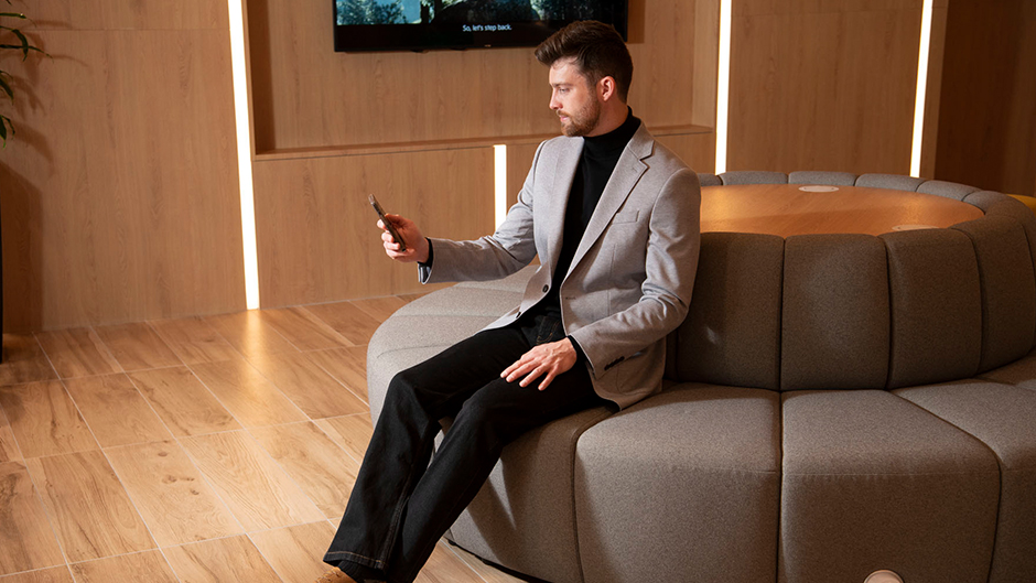 model on phone sitting in the dealership