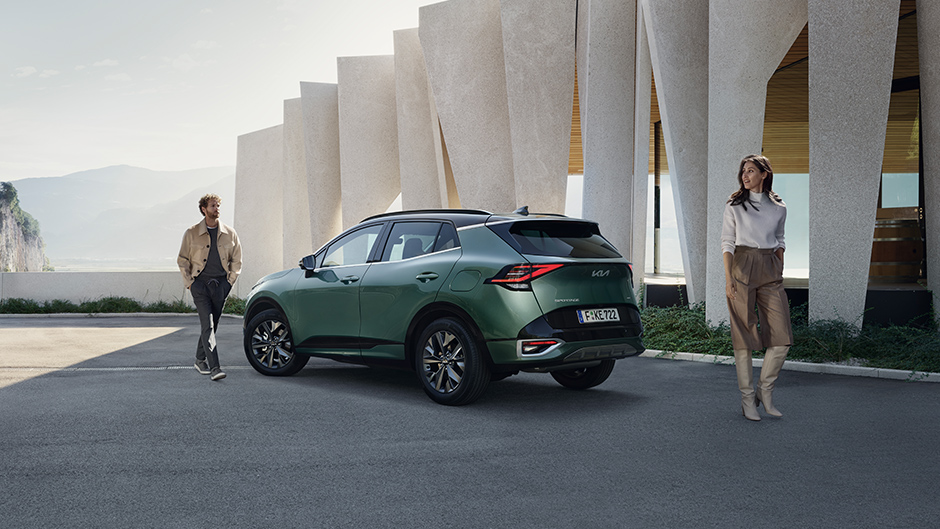 Kia  niro EV back view with model walking towards it